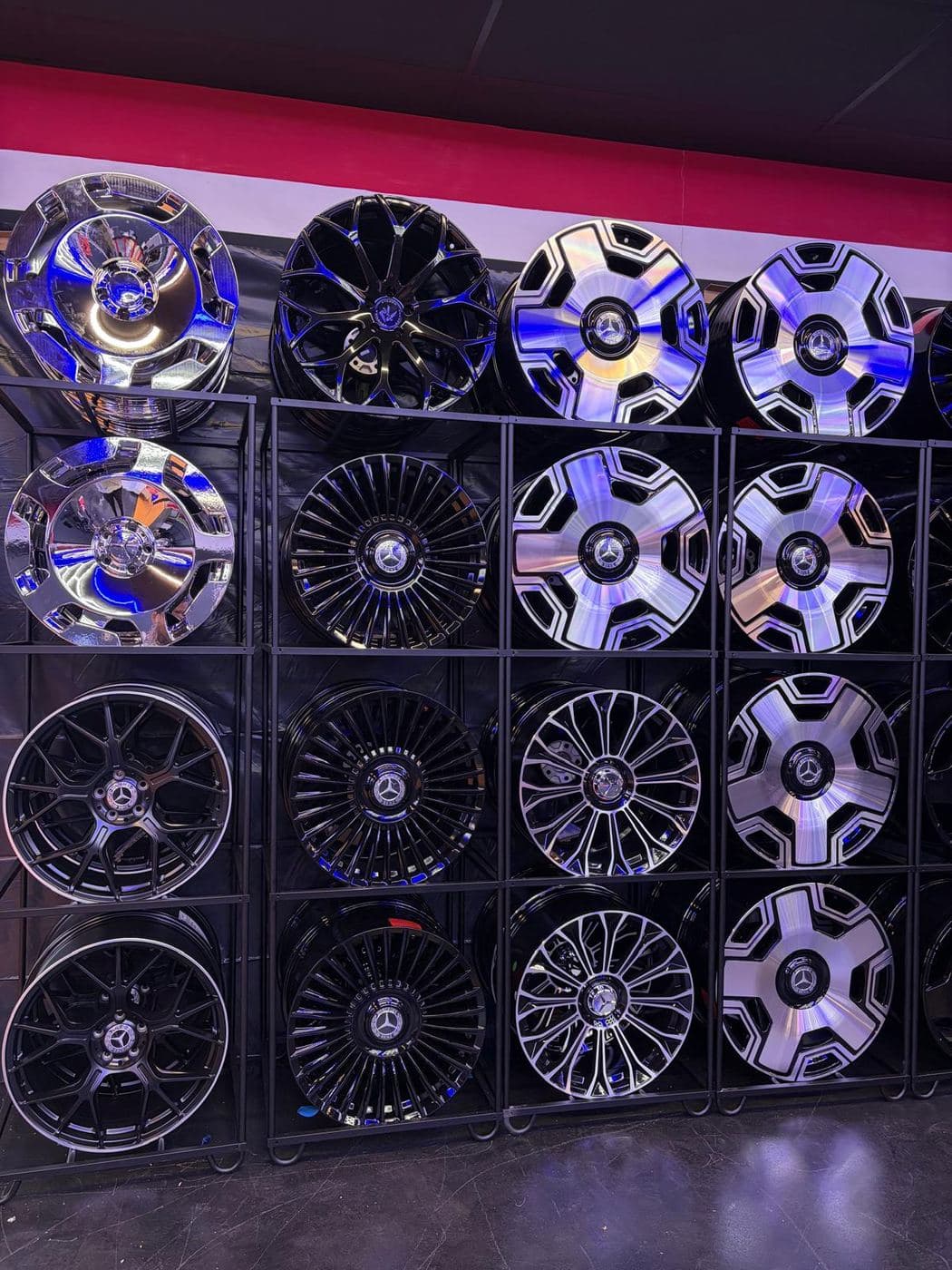 Showroom wall lined with chrome and black wheels